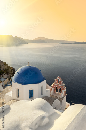 Reflecting sun on a blue dome in Oia