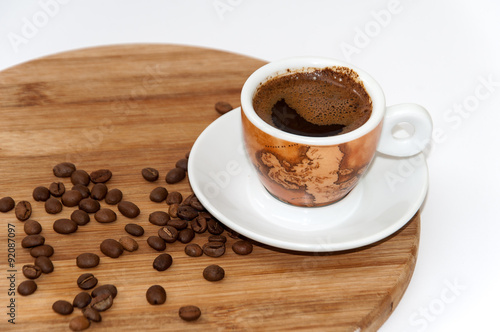 Cup of coffee on the wooden board