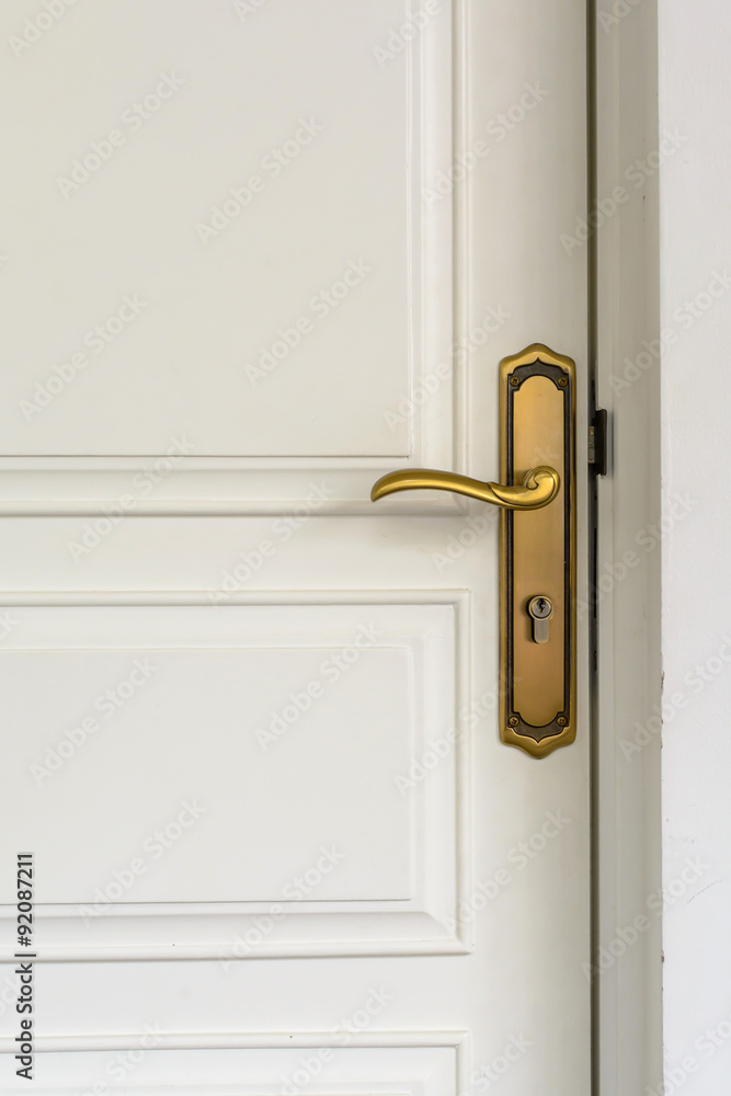 Naklejka premium classic golden door handle on white door