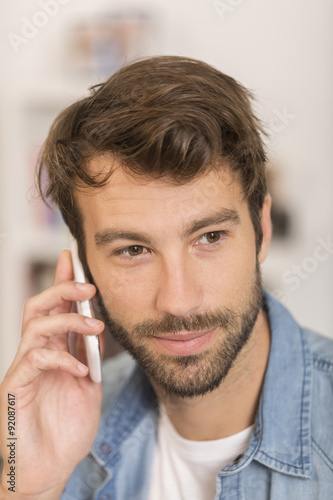 young man talking on phone at home