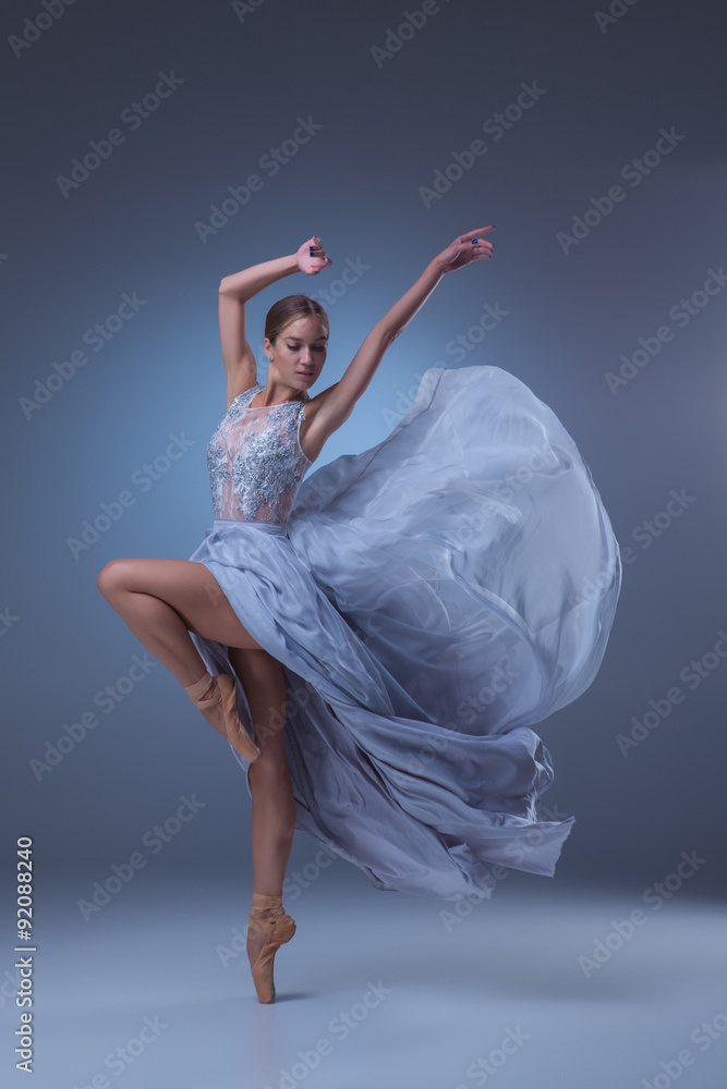 Naklejka premium The beautiful ballerina dancing in blue long dress