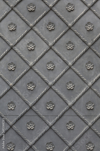 Old metal gate covered with floral pattern. Background texture