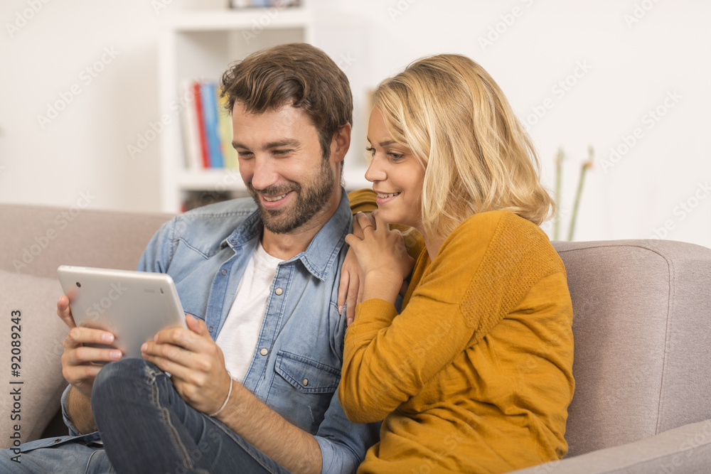 young couple using digital tablet at home young couple using digital tablet at home