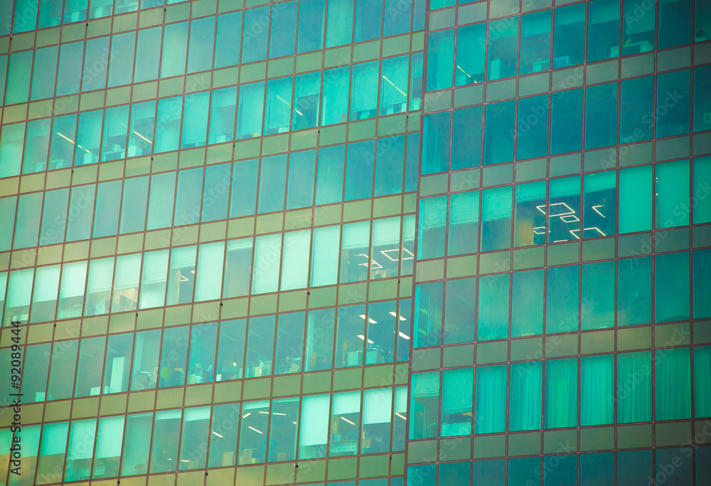 View to steel light blue background of glass high rise building