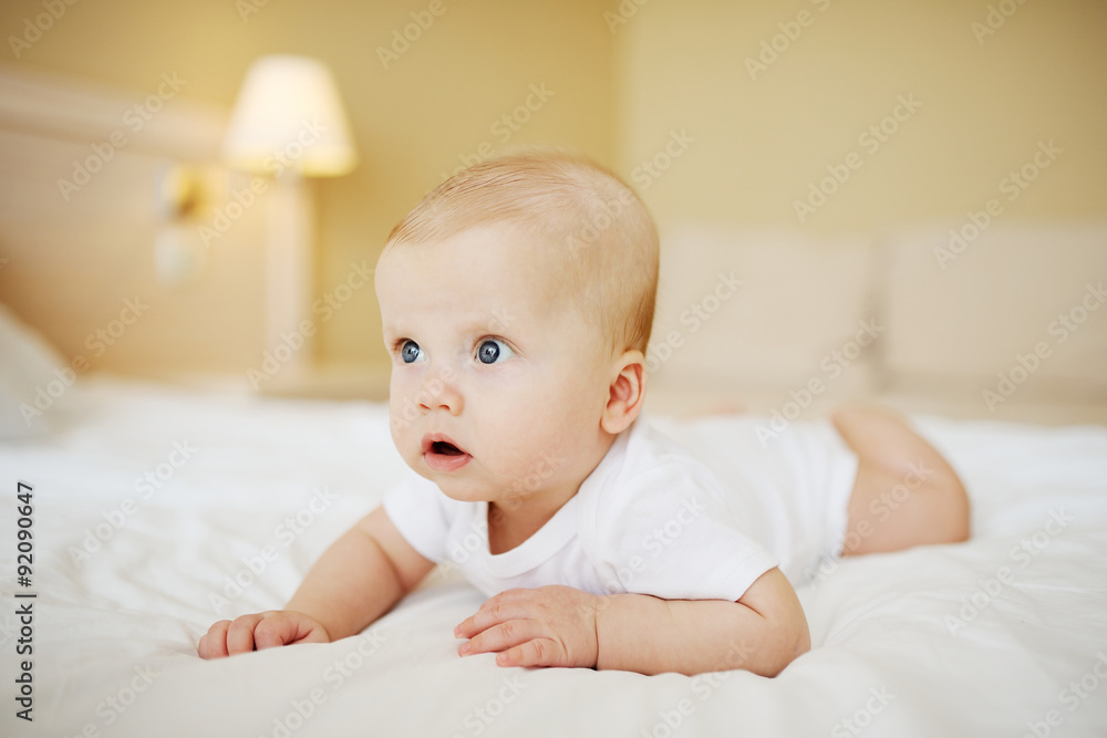 baby boy crawling on the bed