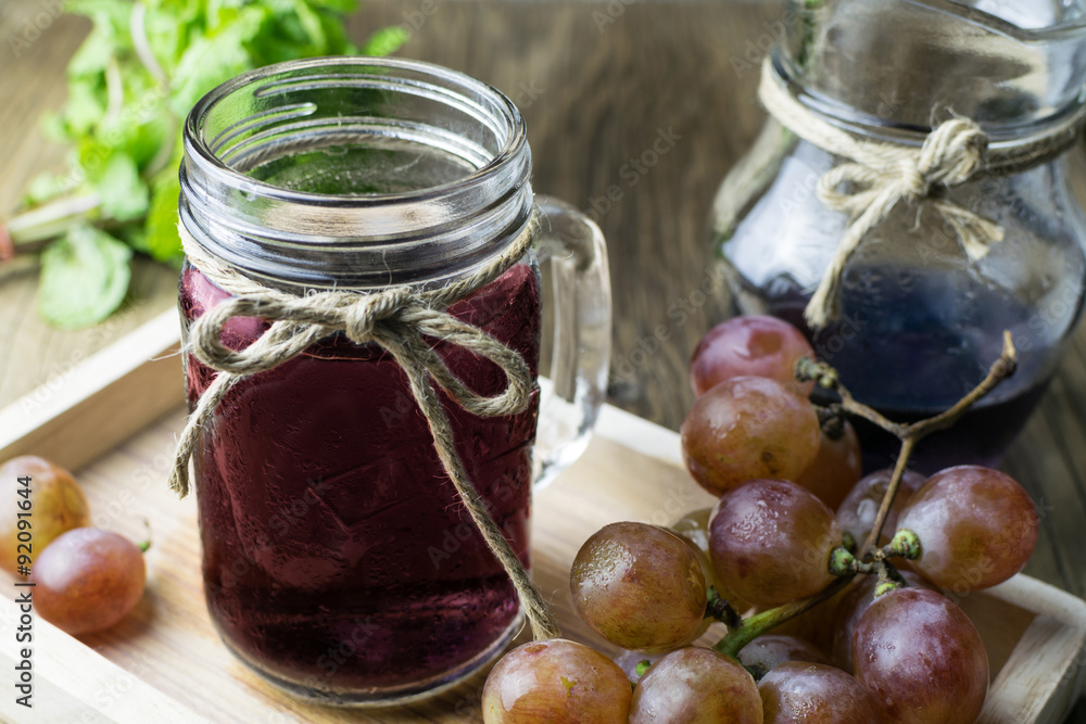 Fresh and juice grapes on wooden table Fresh and juice grapes on wooden table