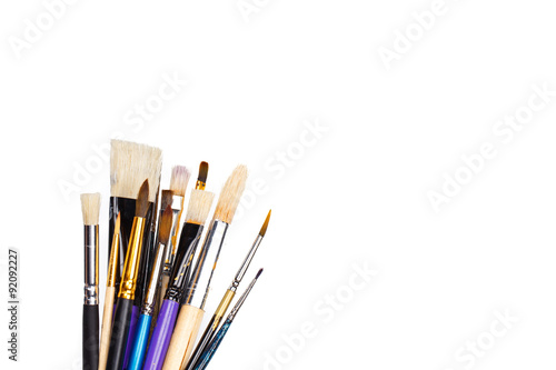 Set of artist paint brushes on white background with much space for text. Isolated image. 