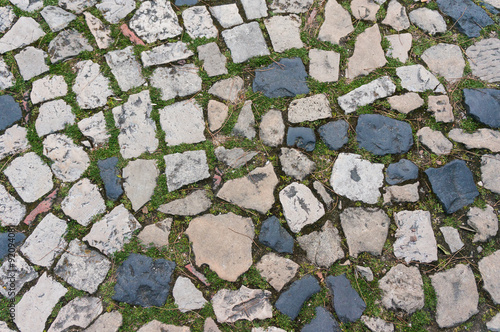 cobble road with grass growing between cobbles