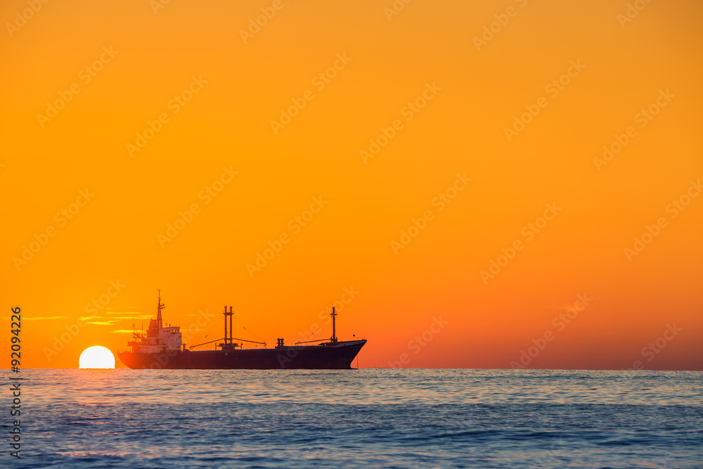 Fisherman sailling with his boat on beautiful sunrise over the sea