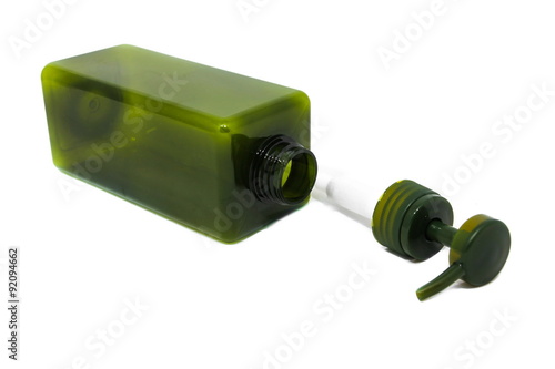 Green cosmetic plastic bottle with dispenser pump.