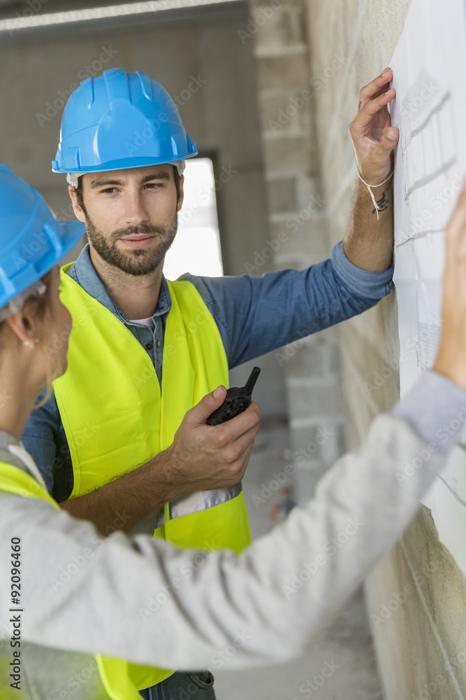 Engineers on building site checking plans Engineers on building site checking plans