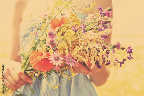 Fototapeta Naklejka Na Ścianę i Meble -  Woman holding beautiful bouquet of wildflowers outdoors