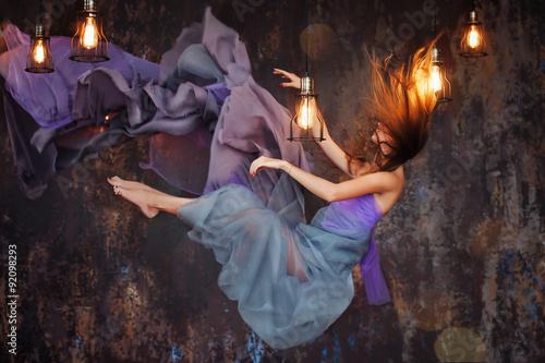 Fotografie Girl hovers in the room at night.