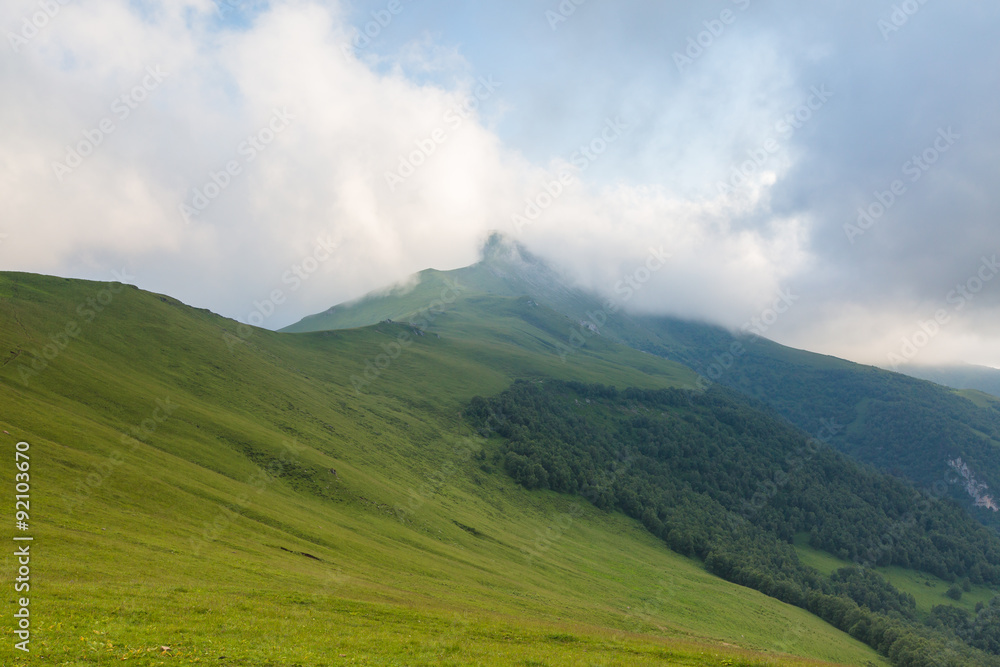 Fototapeta premium Russia, timelapse. The formation and movements of clouds up to the steep slopes of the mountains of Central Caucasus peaks.