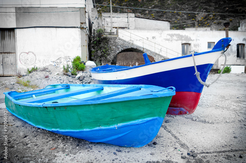 Two painted old boats somewhere on the coast of Sicily, Italy