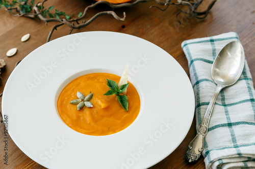 Pumpkin soup in white modern plate, dietary vegetable