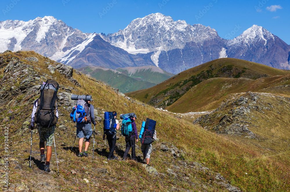 Fototapeta premium Group of tourists with large backpacks are on mountain