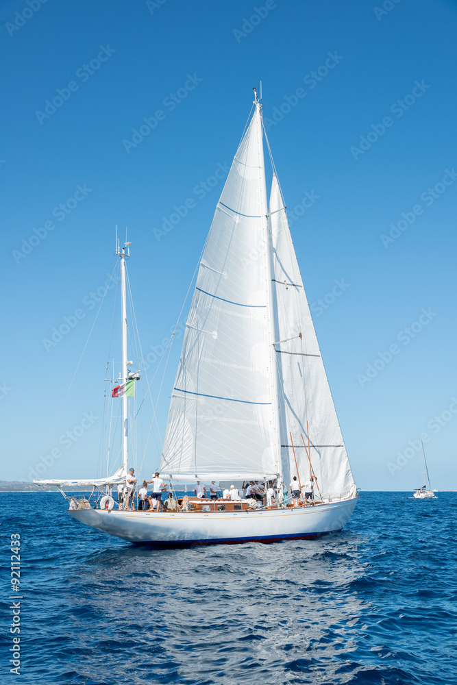 Fototapeta premium Elegant old italian style sailboat, on a wonderful blue sea, Sardinia, Italy
