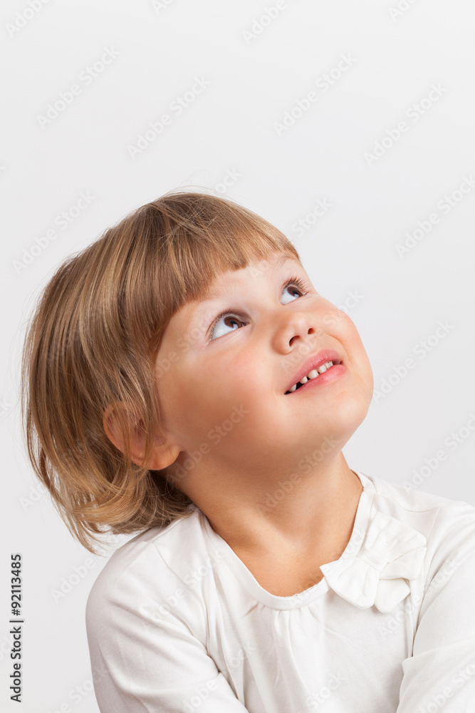 Cute Caucasian little girl looking up, closeup portrait Cute Caucasian little girl looking up, closeup portrait
