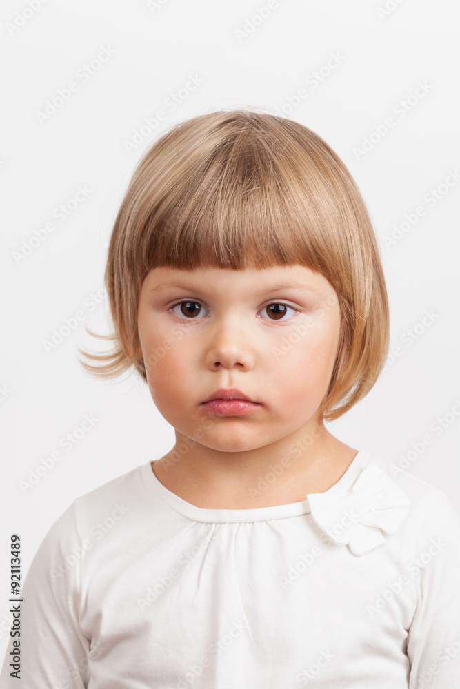 Cute serious Caucasian little girl, closeup portrait Cute serious Caucasian little girl, closeup portrait