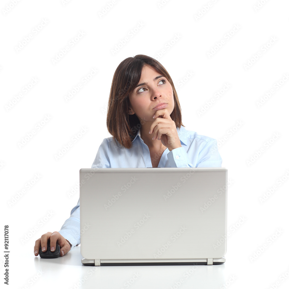 Pensive woman thinking while is using a laptop Pensive woman thinking while is using a laptop