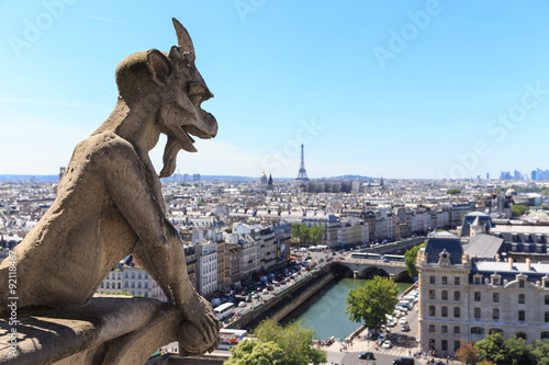 Famous Chimera (demon) overlooking the Eiffel Tower at a summer