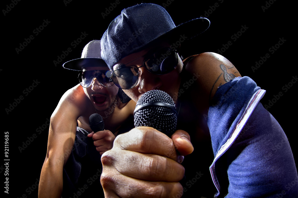 Rappers having a hip hop music concert with microphones - obrazy, fototapety, plakaty 