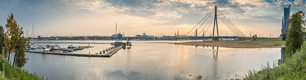 Panoramic view on the Daugava river, old Riga city and modern cable bridge