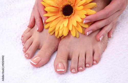 Closeup photo of a beautiful female feet with red pedicure