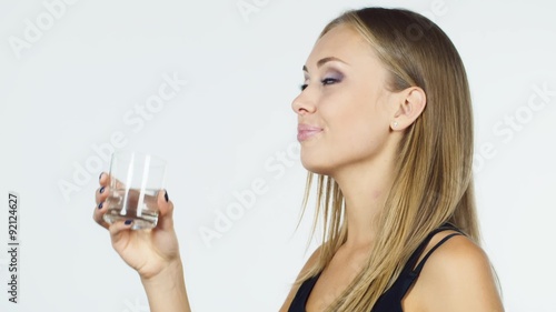 Wallpaper Mural Attractive blonde woman drinks water on a white background Torontodigital.ca