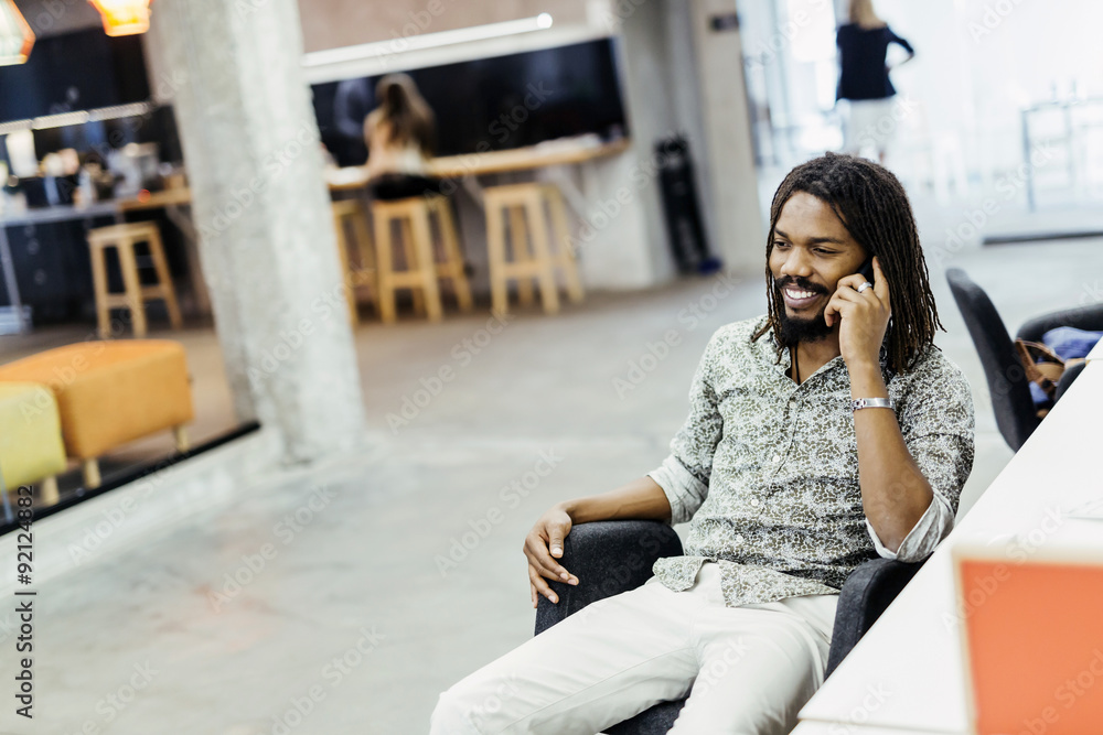Handsome designer smiling while working in an office Handsome designer smiling while working in an office