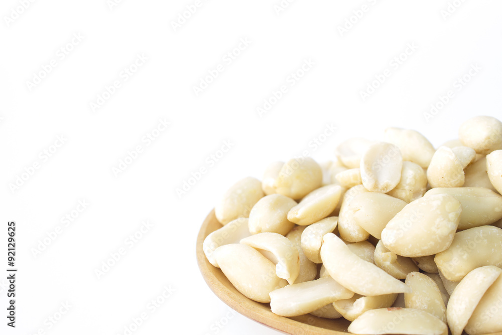 groundnuts on wooden spoon isolated on white background groundnuts on wooden spoon isolated on white background