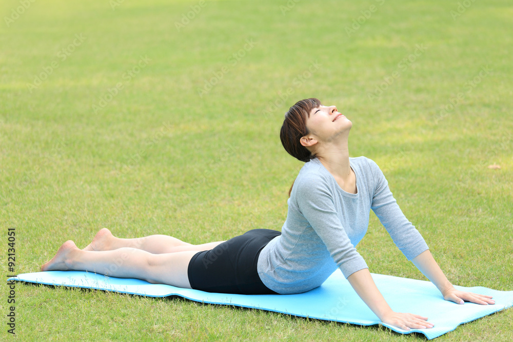 Fototapeta premium Japanese woman doing yoga Cobra Pose