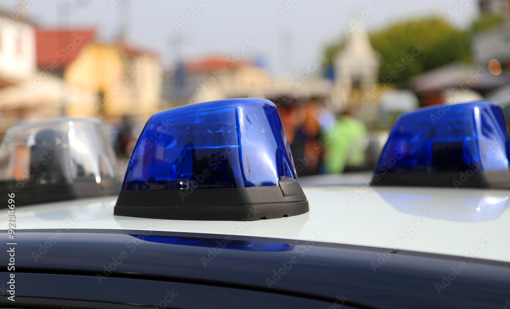 Obraz premium Blue police car siren while patrolling in the city