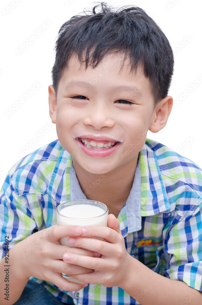 Asian boy drinking a glass of milk over white background Asian boy drinking a glass of milk over white background