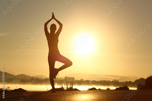 Silhouette of a fitness woman exercising yoga meditation exercise