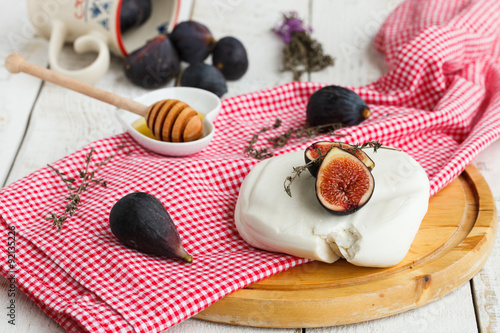 Fresh Fig with cheese on a wooden Board.selective focus
