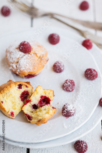 Muffins with raspberries,sprinkled with powdered sugar.selective focus