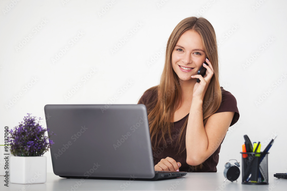 Portrait of young business woman working at her office.