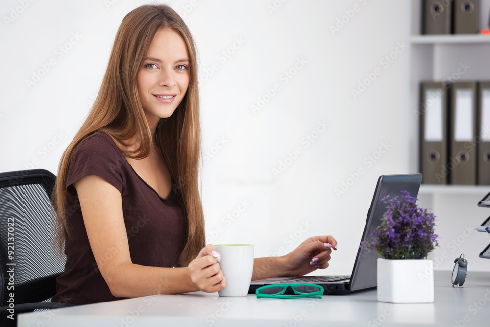 Portrait of young business woman working at her office. Portrait of young business woman working at her office.