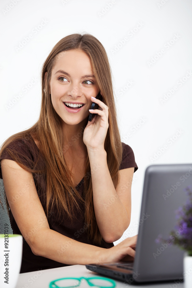 Portrait of young business woman working at her office. Portrait of young business woman working at her office.
