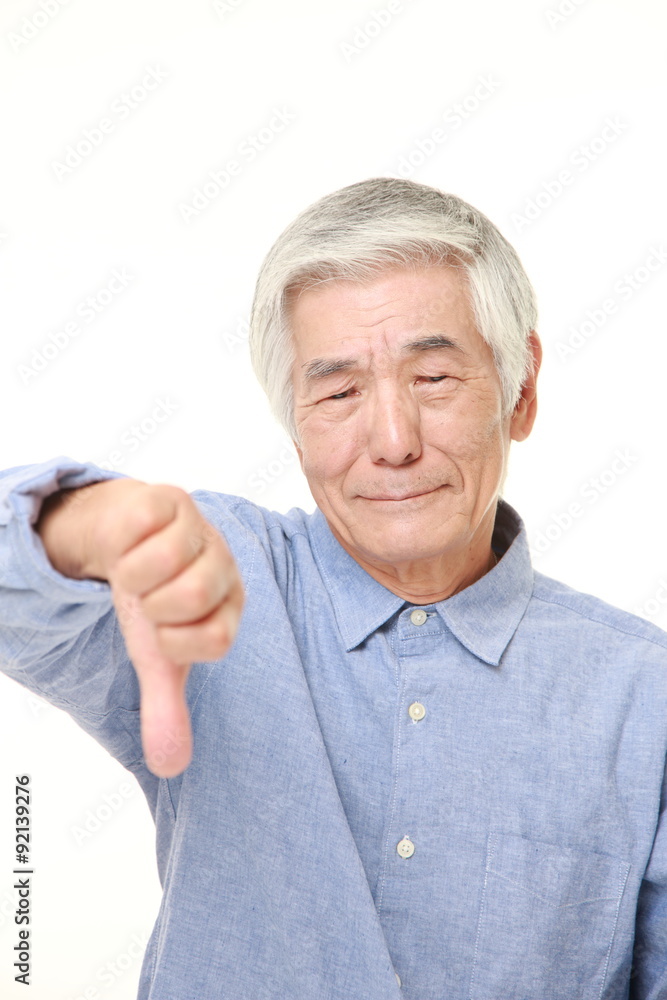 senior Japanese man with thumbs down gesture senior Japanese man with thumbs down gesture