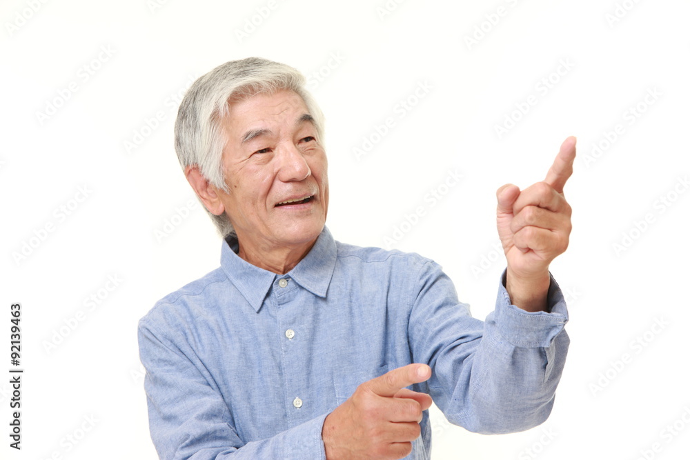 senior Japanese man presenting and showing something senior Japanese man presenting and showing something