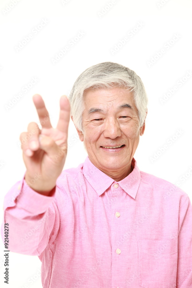 senior Japanese man showing a victory sign senior Japanese man showing a victory sign