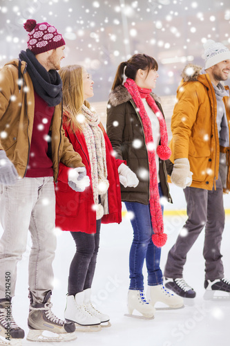 happy friends on skating rink