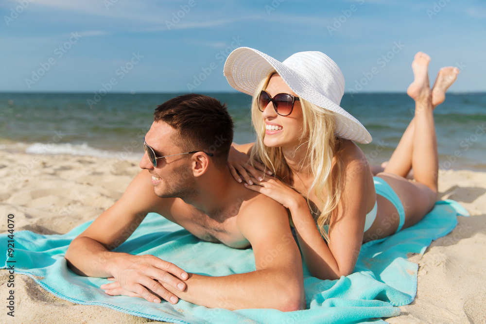 happy couple in swimwear lying on summer beach happy couple in swimwear lying on summer beach