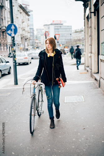 young beautiful hipster sporty blonde woman walking in the stree