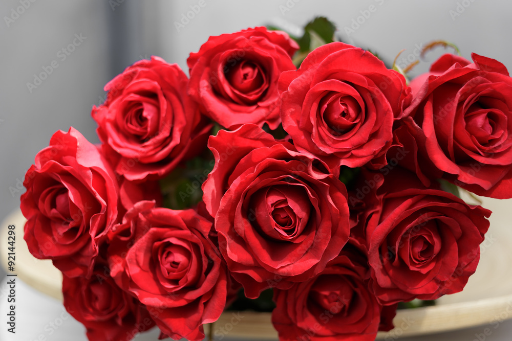 bouquet of red roses lying on a plate bouquet of red roses lying on a plate