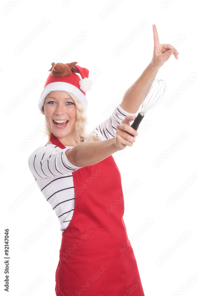 Weihnachtsfrau mit Schneebesen zeigt auf etwas Weihnachtsfrau mit Schneebesen zeigt auf etwas