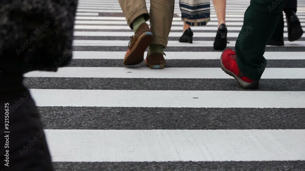 Footsteps of commuters in famous Shibuya crosswalk at rush hour in Tokyo, Japan Footsteps of commuters in famous Shibuya crosswalk at rush hour in Tokyo, Japan